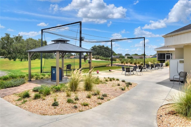 surrounding community with a gazebo, a patio area, and a lawn