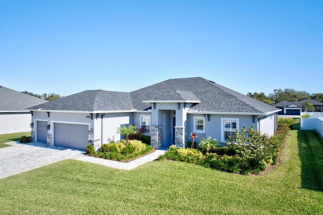 view of front of house with a front lawn and a garage