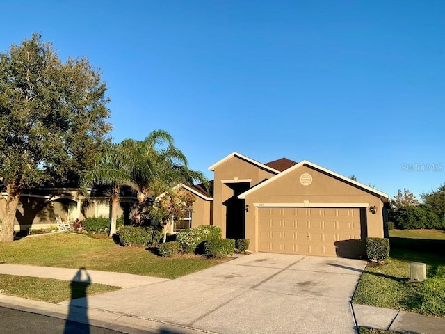 view of front of home with a garage and a front lawn