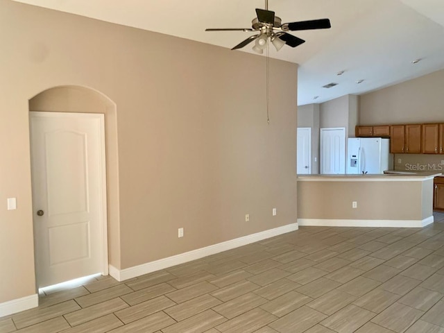 unfurnished living room with ceiling fan and lofted ceiling