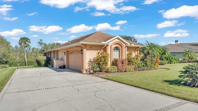 view of front of house with a front yard and a garage