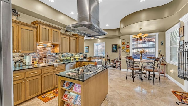 kitchen with a center island, sink, an inviting chandelier, island range hood, and appliances with stainless steel finishes