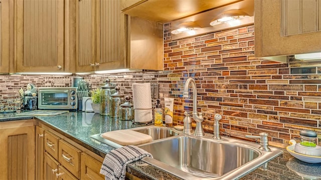 kitchen with backsplash, light brown cabinets, and sink