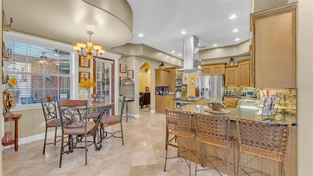 dining room featuring light tile patterned floors and an inviting chandelier