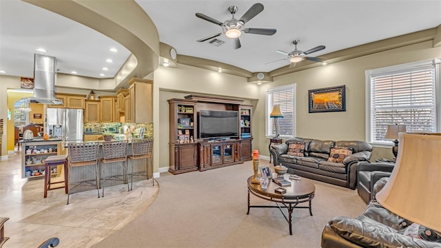 living room featuring light tile patterned floors and ceiling fan