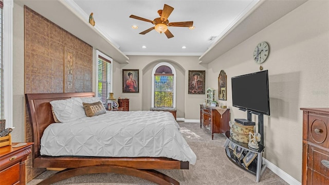 carpeted bedroom with ceiling fan and crown molding