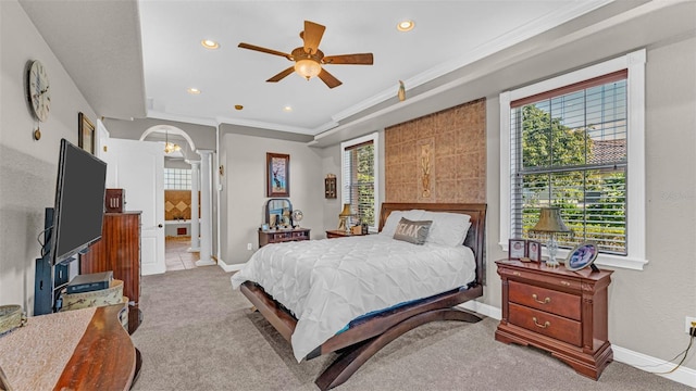 bedroom with ceiling fan, ornamental molding, light carpet, and ensuite bath