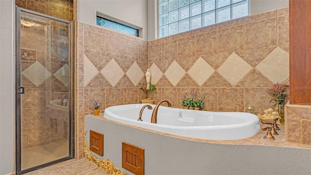 bathroom featuring plenty of natural light, tile walls, and shower with separate bathtub