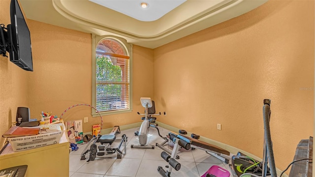 workout area featuring light tile patterned floors