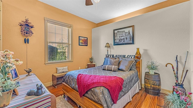 bedroom with wood-type flooring and ceiling fan