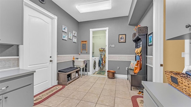 interior space with tile patterned floors and independent washer and dryer