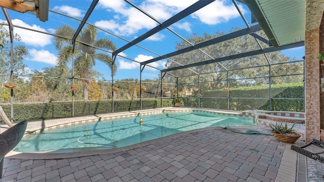 view of swimming pool featuring glass enclosure and a patio area