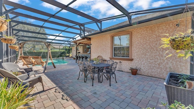 view of patio / terrace featuring a lanai and pool water feature