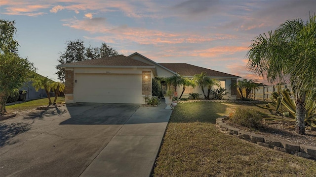 ranch-style home with a yard and a garage