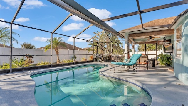 view of swimming pool with a lanai, ceiling fan, and a patio area