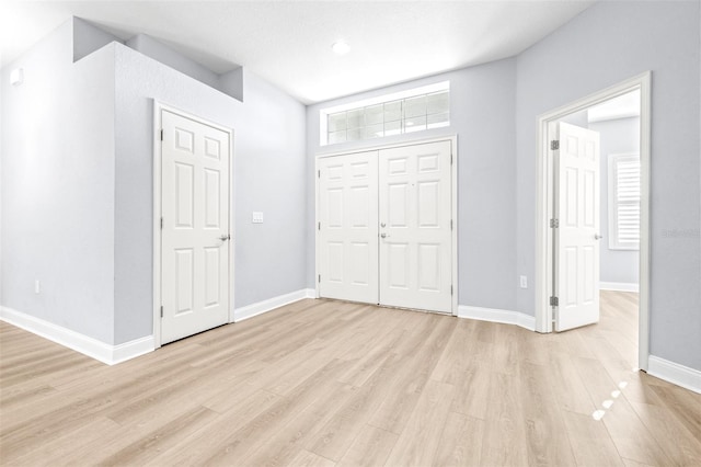 unfurnished bedroom with light wood-type flooring and a closet