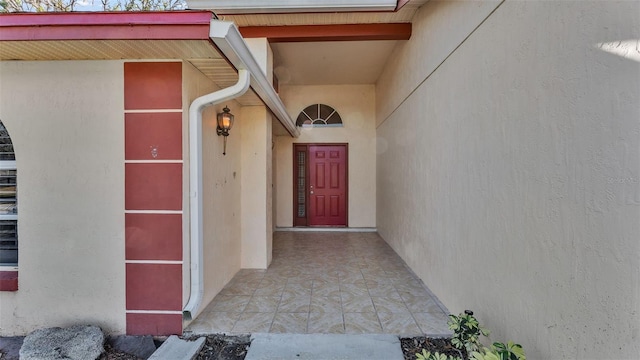 entrance to property featuring stucco siding