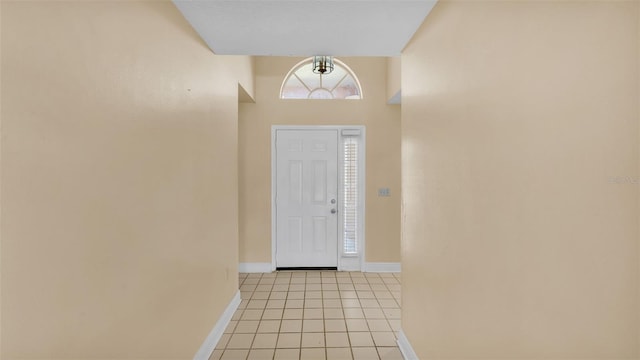 entrance foyer with light tile patterned floors and baseboards