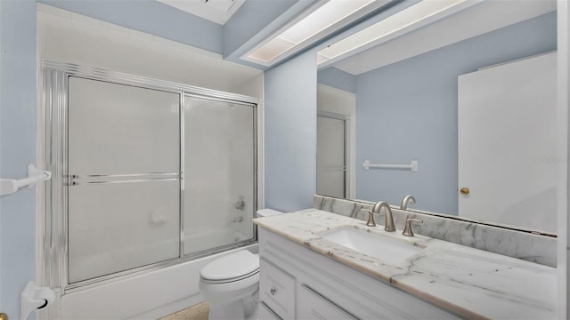 bathroom with shower / bath combination with glass door, vanity, and toilet