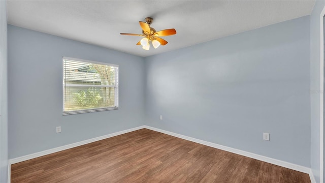 spare room with ceiling fan, baseboards, and wood finished floors