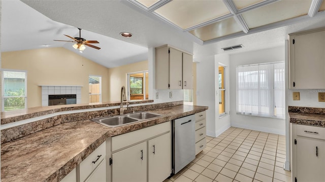 kitchen featuring a wealth of natural light, a sink, lofted ceiling, and stainless steel dishwasher