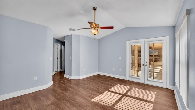 empty room featuring french doors, ceiling fan, vaulted ceiling, wood finished floors, and baseboards