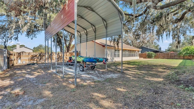 view of yard with a fenced backyard and a detached carport