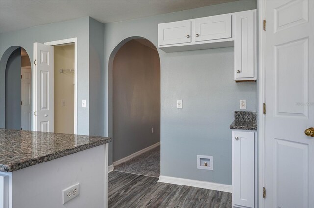 kitchen featuring white cabinetry, dark hardwood / wood-style flooring, and dark stone counters