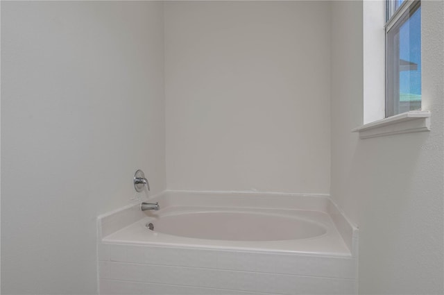 bathroom featuring tiled bath