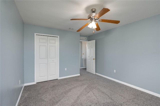 unfurnished bedroom with ceiling fan, carpet floors, and a closet