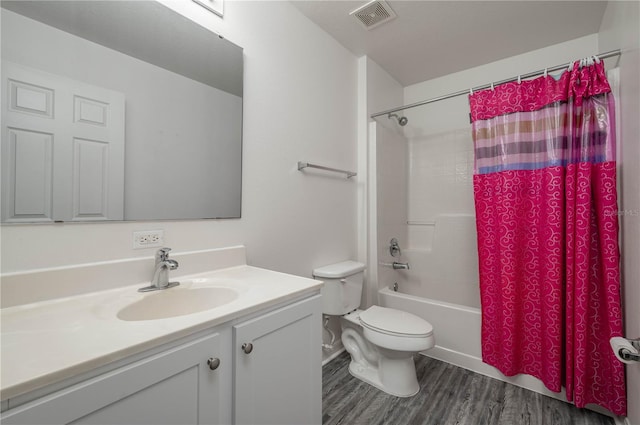 full bathroom featuring shower / bath combo with shower curtain, hardwood / wood-style floors, vanity, and toilet