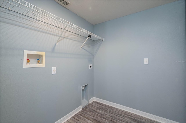 clothes washing area with hardwood / wood-style flooring, electric dryer hookup, and hookup for a washing machine