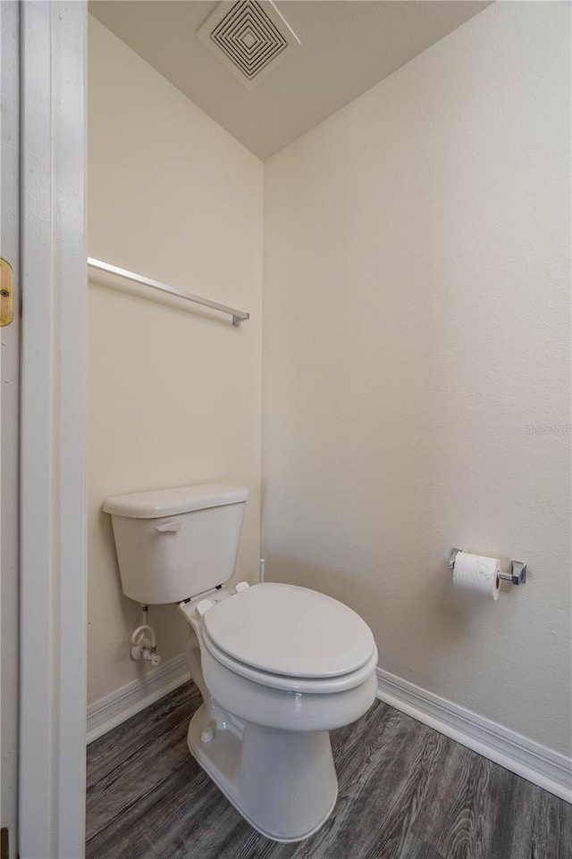 bathroom with hardwood / wood-style floors and toilet