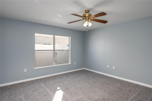 empty room with ceiling fan and carpet