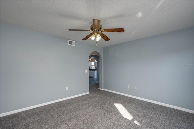 carpeted empty room with ceiling fan and a textured ceiling