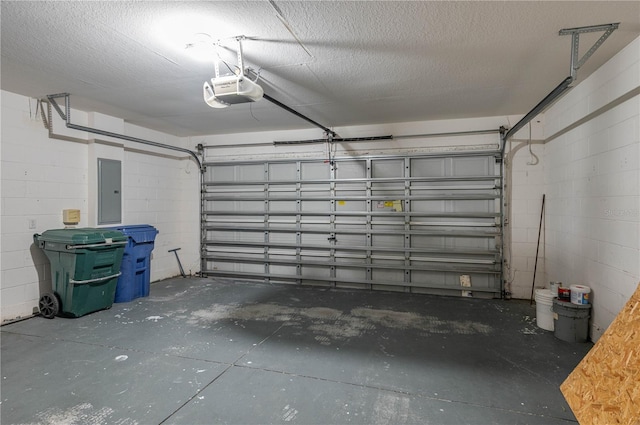 garage featuring electric panel and a garage door opener