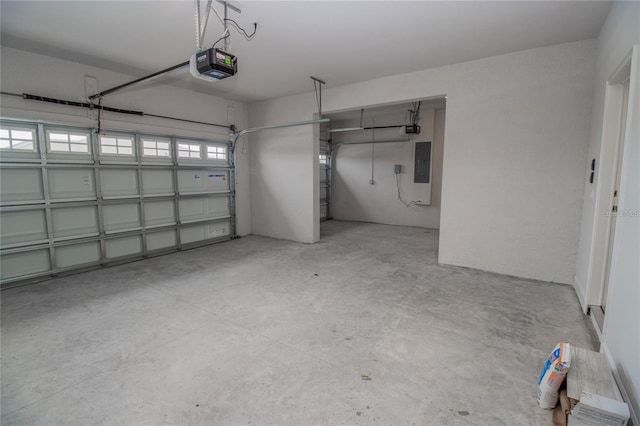 garage with electric panel and a garage door opener