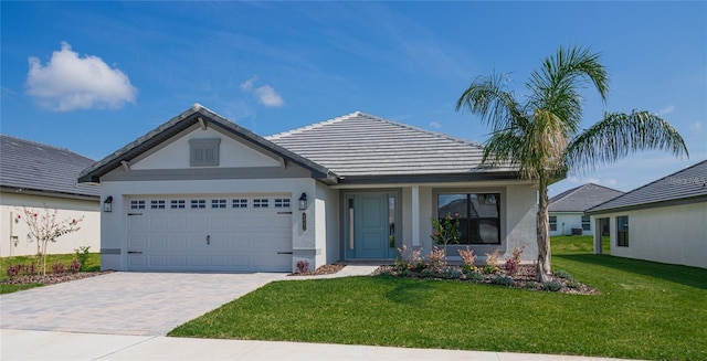 view of front of property with a garage and a front lawn