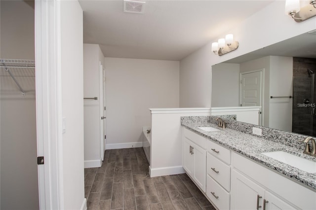 5108 Villa Crest Way, Auburndale, FL 33823 - full bath with double vanity, a bath, wood tiled floors, a tile shower, and a spacious closet