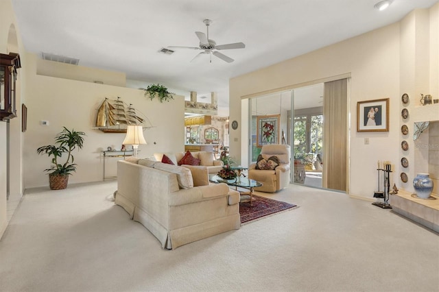 carpeted living room with ceiling fan