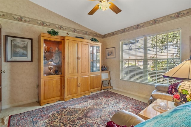 living area with carpet, vaulted ceiling, and ceiling fan