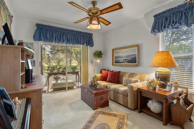 carpeted living room with ceiling fan