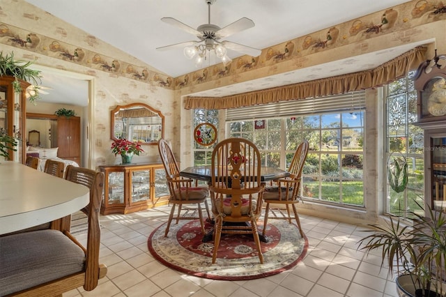 dining room featuring ceiling fan, light tile patterned floors, and lofted ceiling