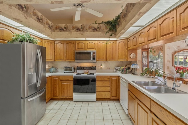 kitchen featuring ceiling fan, sink, light tile patterned floors, and appliances with stainless steel finishes