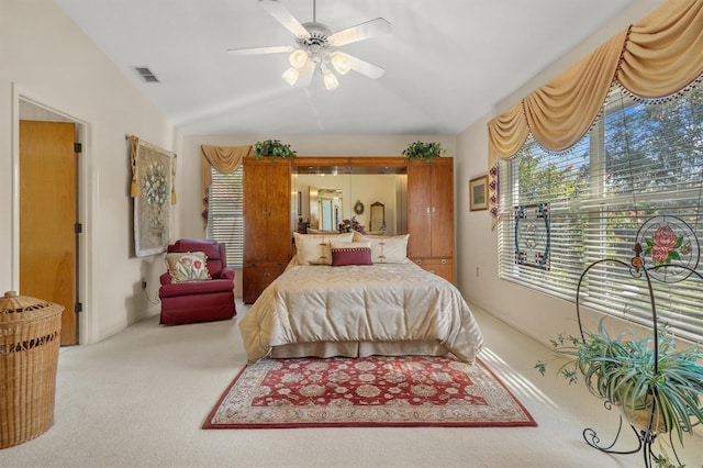 carpeted bedroom with vaulted ceiling and ceiling fan