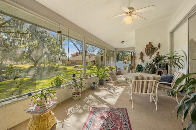 sunroom featuring ceiling fan and lofted ceiling