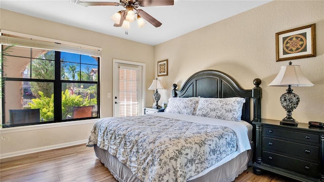 bedroom with light hardwood / wood-style flooring and ceiling fan