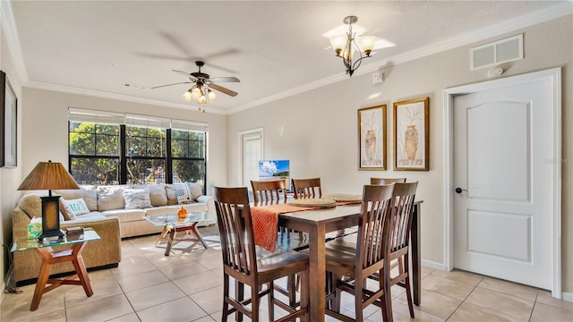 dining area with ceiling fan with notable chandelier, light tile patterned flooring, and ornamental molding