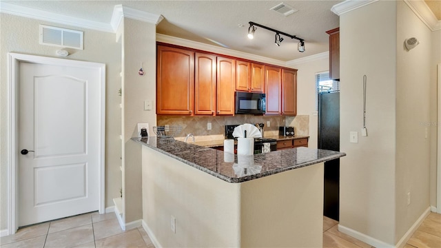 kitchen with kitchen peninsula, a textured ceiling, dark stone counters, and black appliances