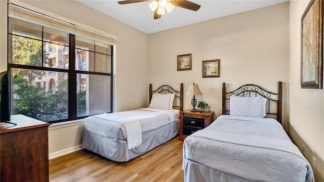 bedroom featuring ceiling fan and light hardwood / wood-style flooring